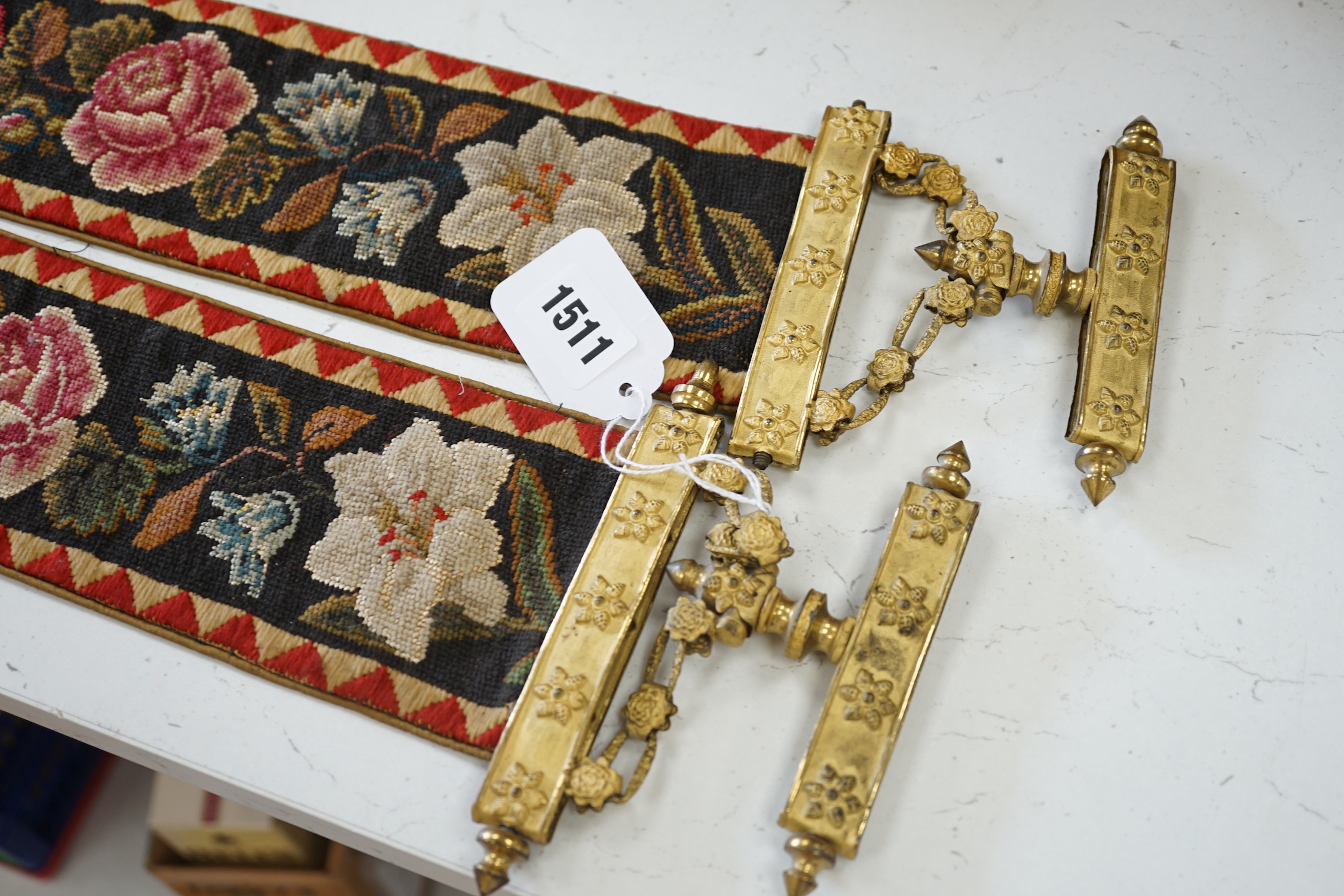 A pair of Victorian petit pointe embroidered bell pulls, 163cm including gilt metal hanger and silk rosette